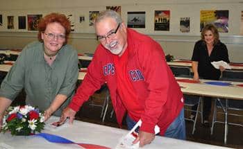 Debi Zaft, Ray Dorman and Debra Smith Dorfman set up the tables