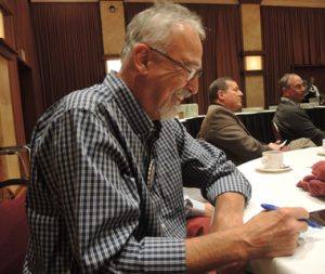 Layne Bowen contemplating who he will invite as a guest to Rotary